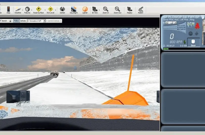 A simulator screen shows a snow plow clearing a snowy highway. The view is from inside the cab, showing the windshield, orange plow blade, and dashboard controls, with snow-covered road and vehicles ahead.